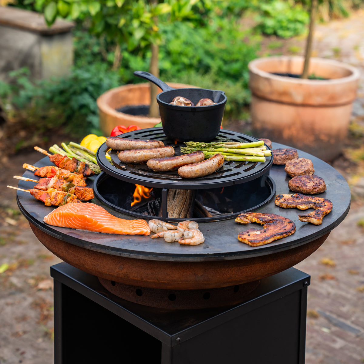 Brasero BBQ Plancha Grill Acero Corten Camarada 2.0 - Con tapa y depósito de leña Ø70cm